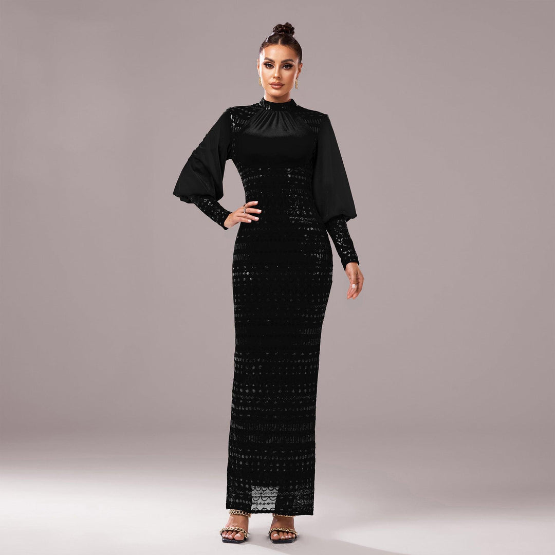 Black sequined evening dress, long sleeves, high round neck, fitted with side slit.