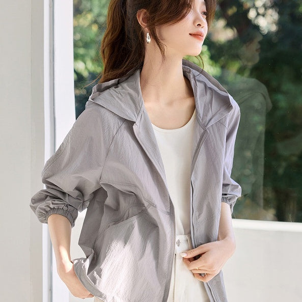 Light gray hooded zip-up windbreaker jacket with elastic cuffs and side pockets