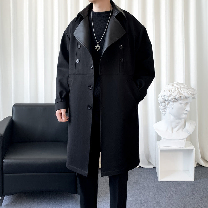 Youth black trench coat with raised lapels, buttoned pockets, and long double-breasted length