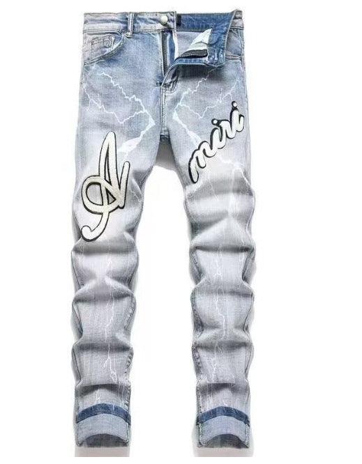 Light blue slim jeans with script style print and distressed, ripped areas