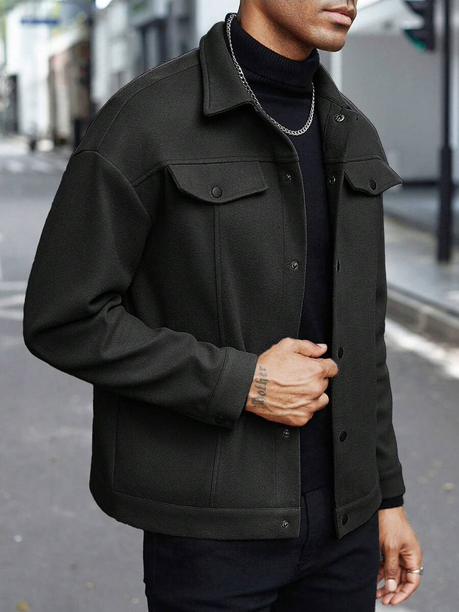 Men’s black wool jacket with button front, pointed collar, and flap chest pockets