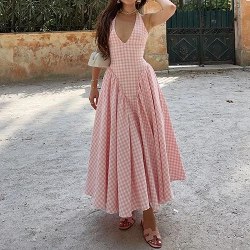 Pink gingham V-neck halter dress with pleated midi skirt and fitted waistline