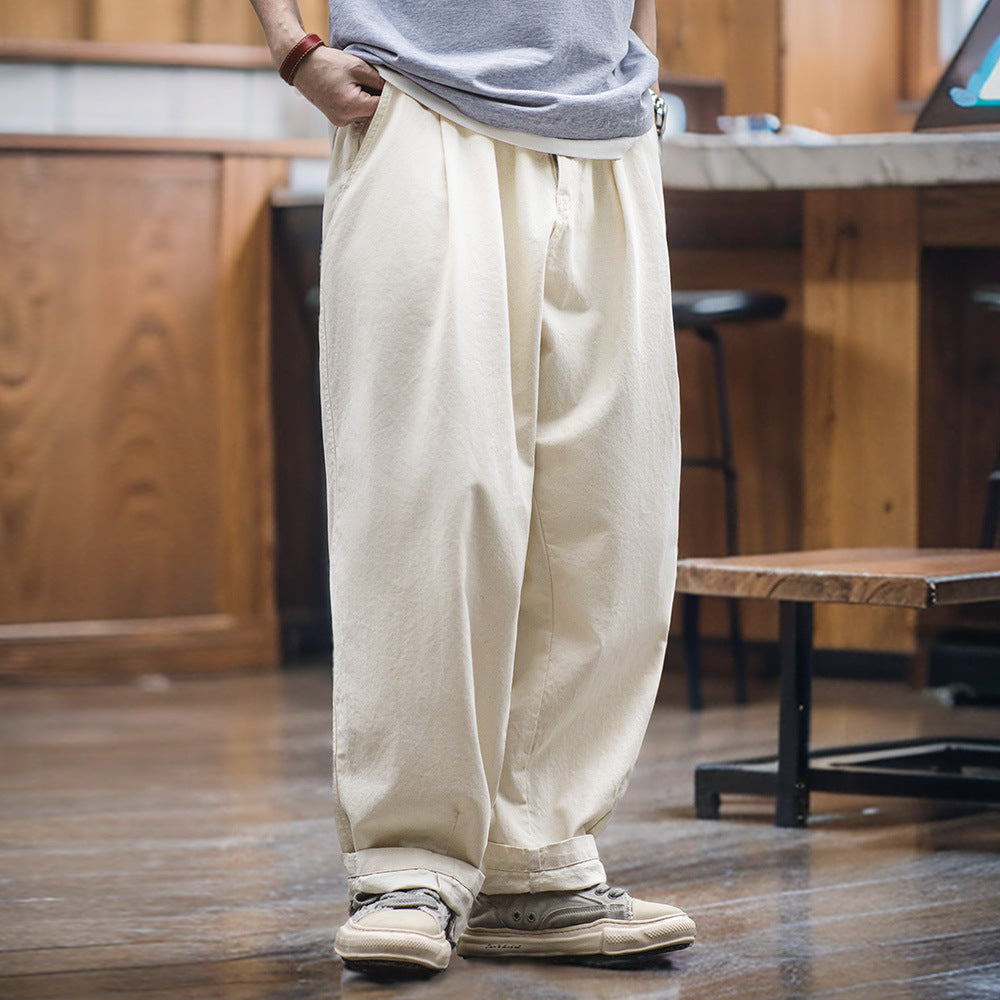 Cream wide-leg leisure pants with relaxed fit and drawstring waist