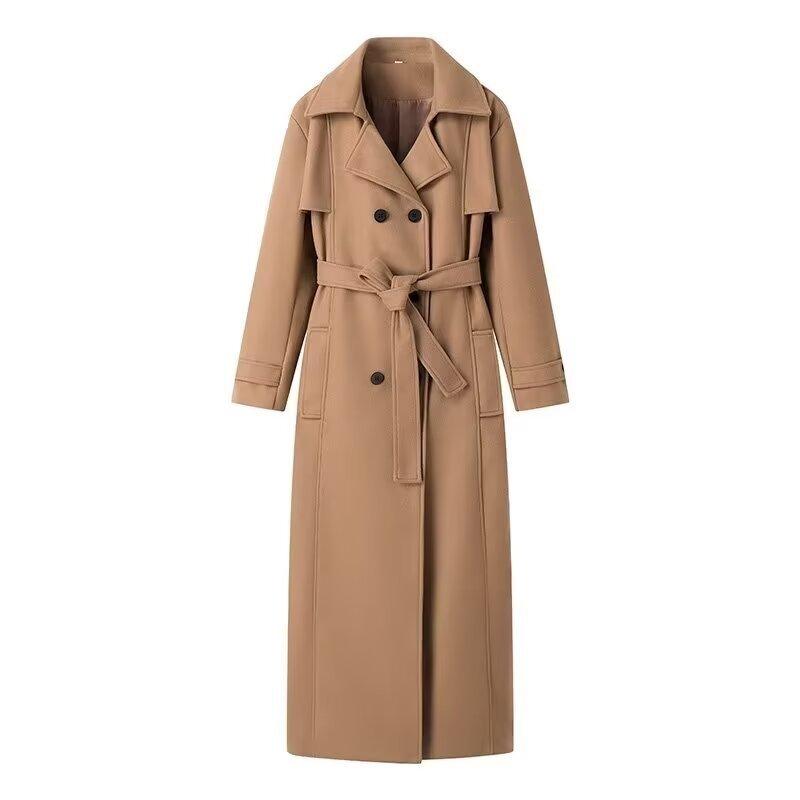 Front view of tan mid-length wool trench coat with belt and double flap pockets.