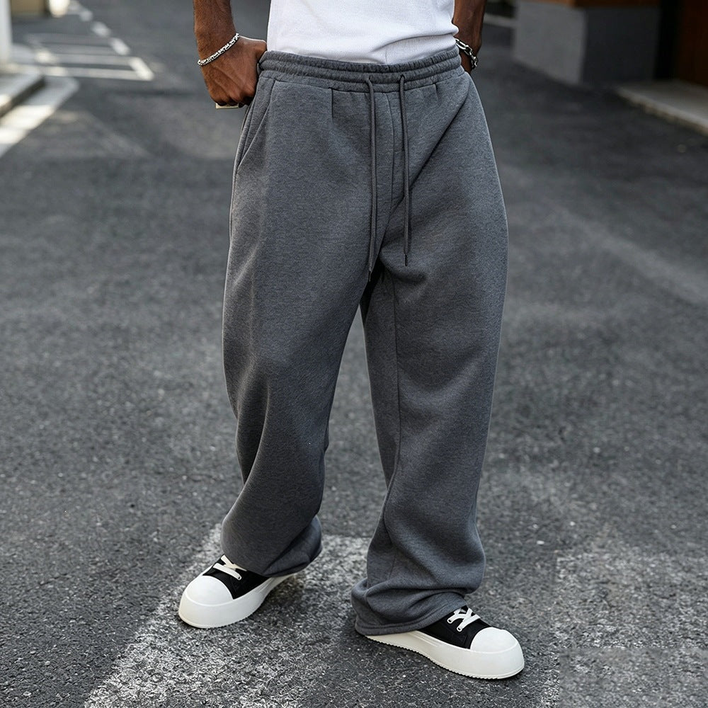 Dark gray elastic-waist sweatpants with drawstring, relaxed straight-leg silhouette.