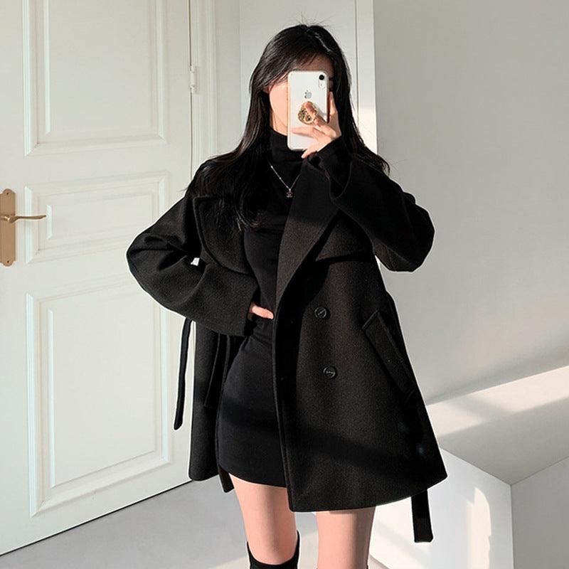 Black wool coat with loose collar, button front and belted tie with lace-up detail