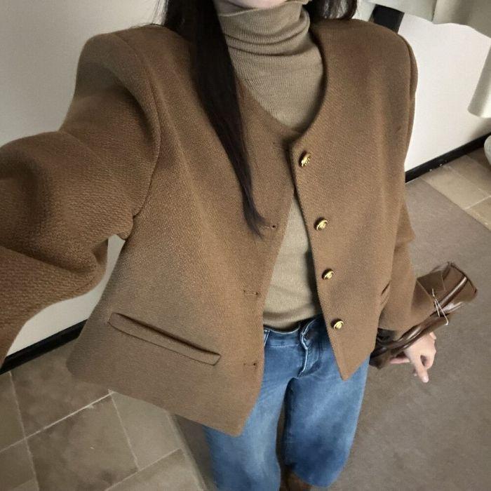 Chestnut brown button-front short jacket with gold buttons and structured sleeves