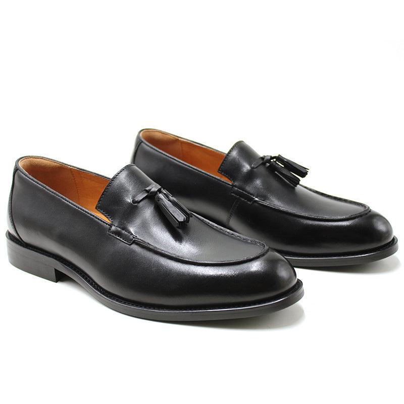 Men's black tassel loafers with moc toe, fringe tassel accents, and low rubber sole