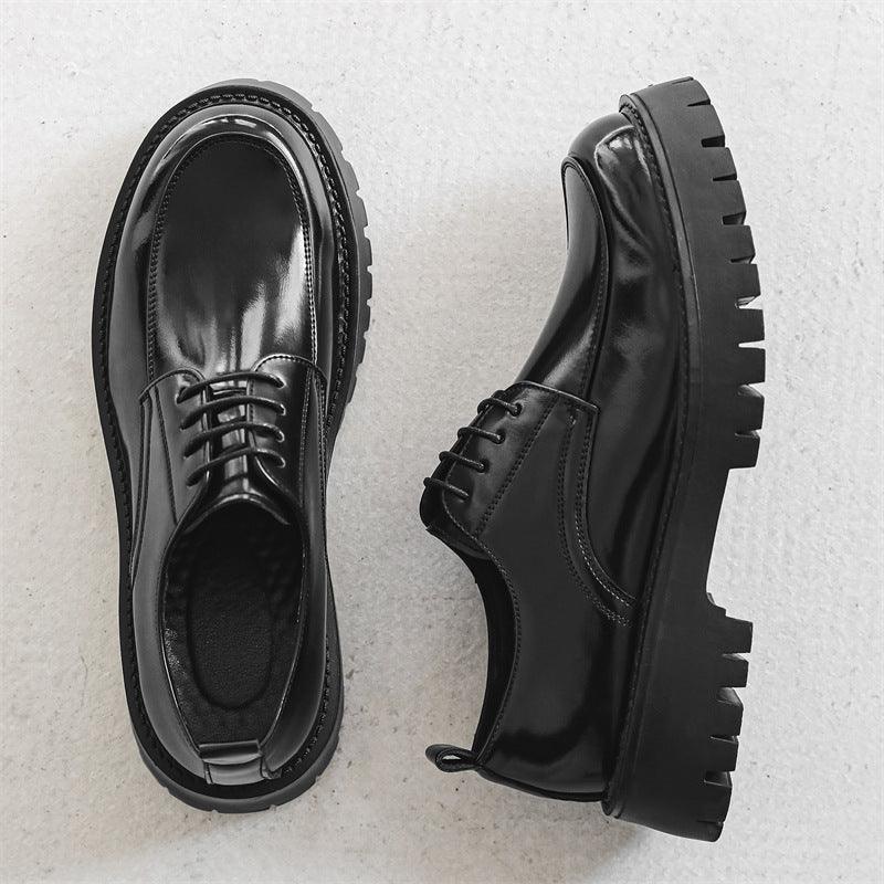 Black leather lace-up shoes with thick outsole and textured tread sole detail