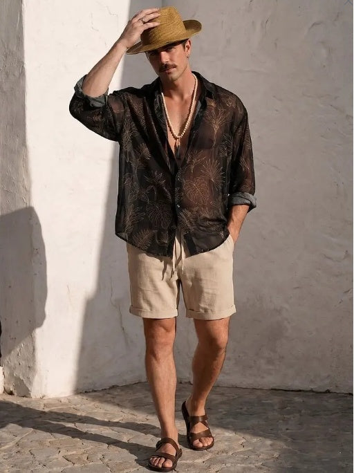 Sheer oversized black shirt with dark botanical print, loose fit and rolled sleeves