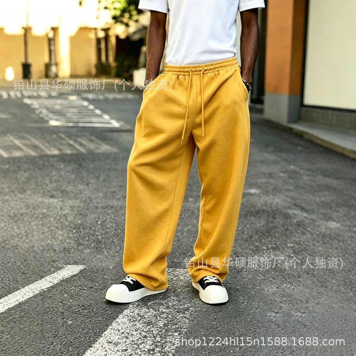 Mustard yellow fleece-lined sweatpants with elastic drawstring waist and tapered cuffs