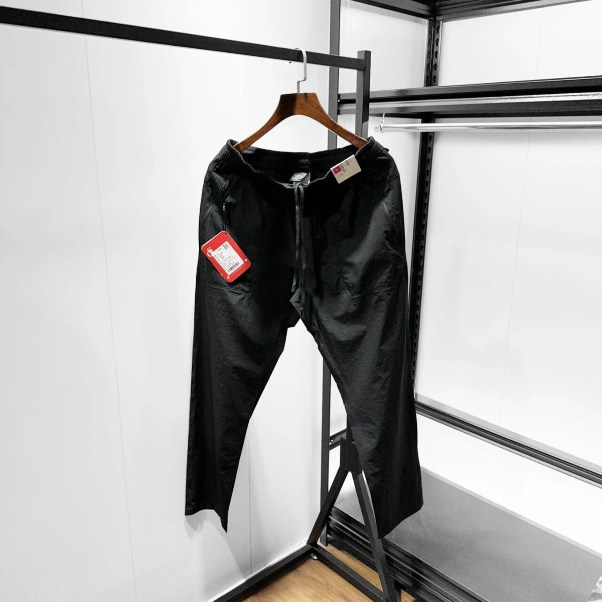Men’s black softshell pants on hanger, elastic waist and drawstring