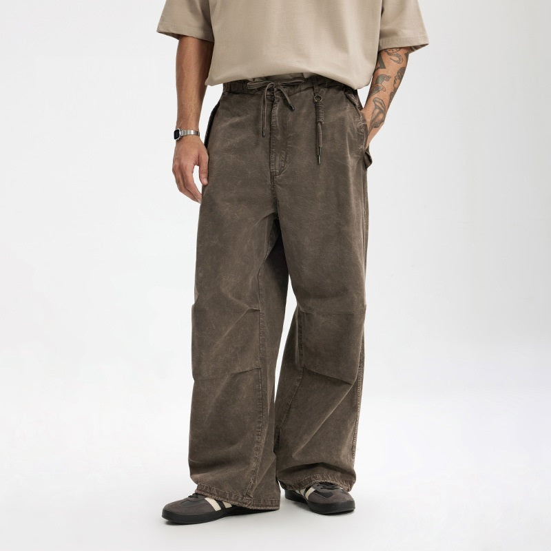 Washed paratrooper overalls in dark gray-brown with drawstring waist and flap cargo pockets