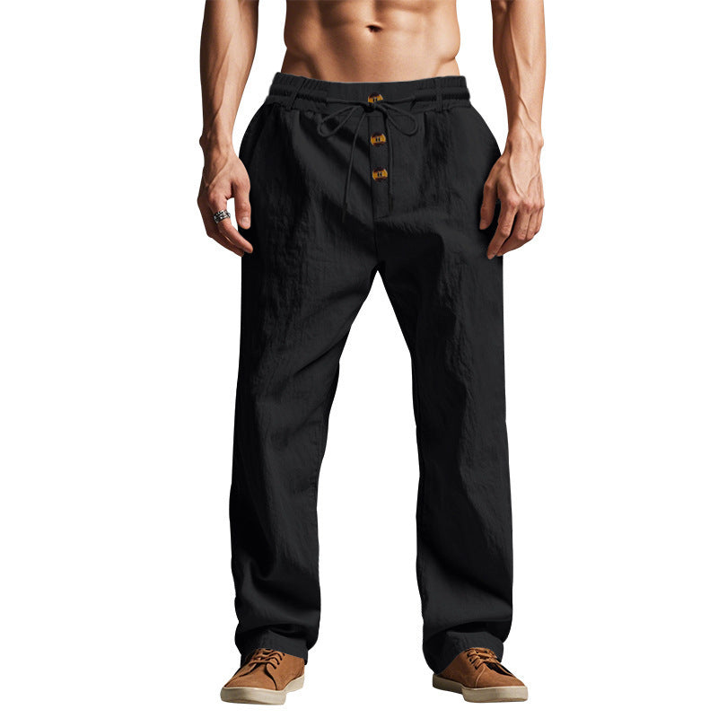 Men's black linen trousers with drawstring waist and button placket, straight relaxed fit