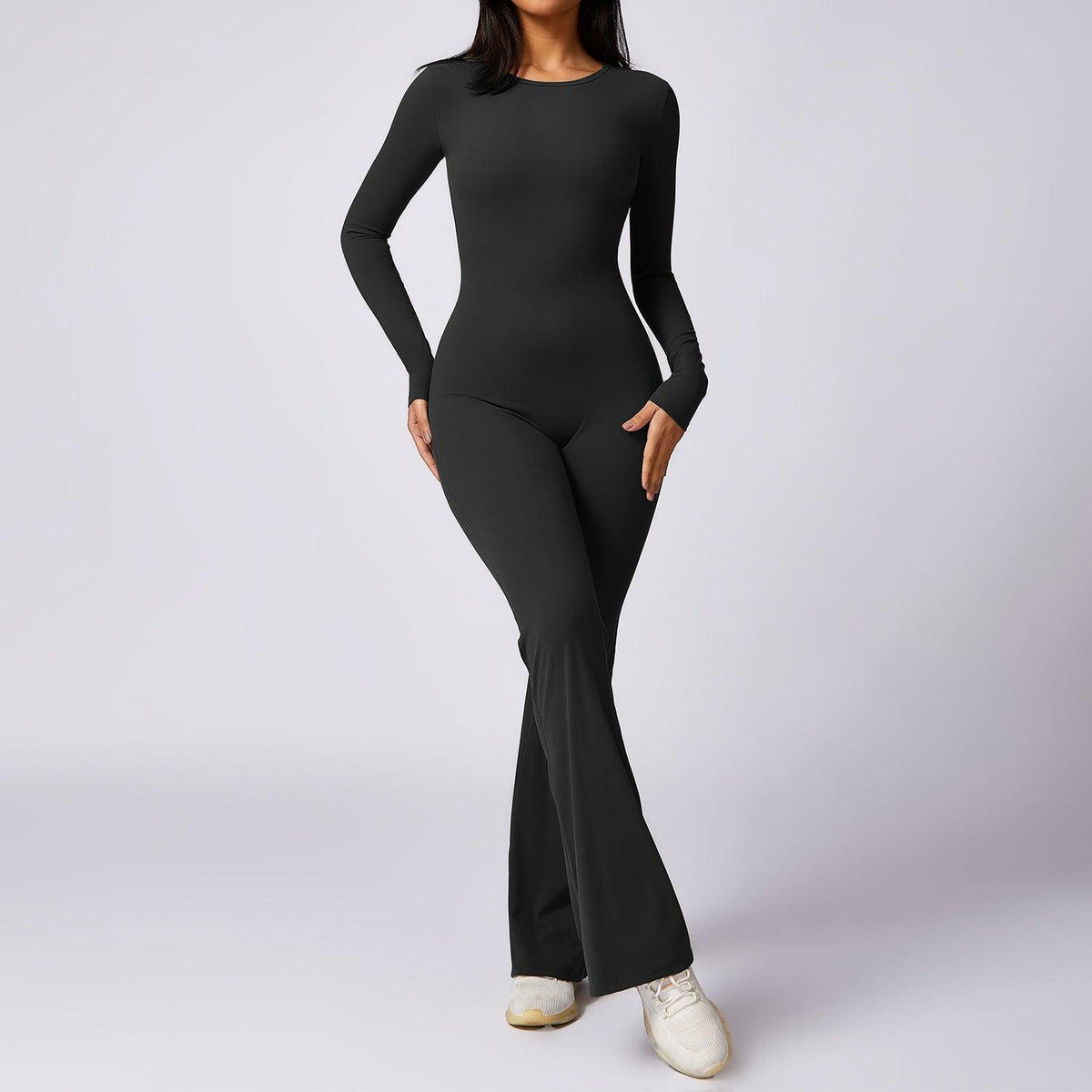 Black long-sleeve yoga jumpsuit with high-waist fit and flared ankle