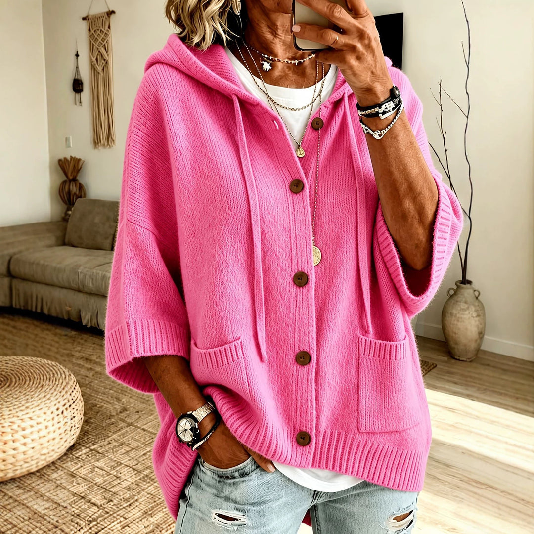 Pink hooded knit coat with button front and patch pockets.