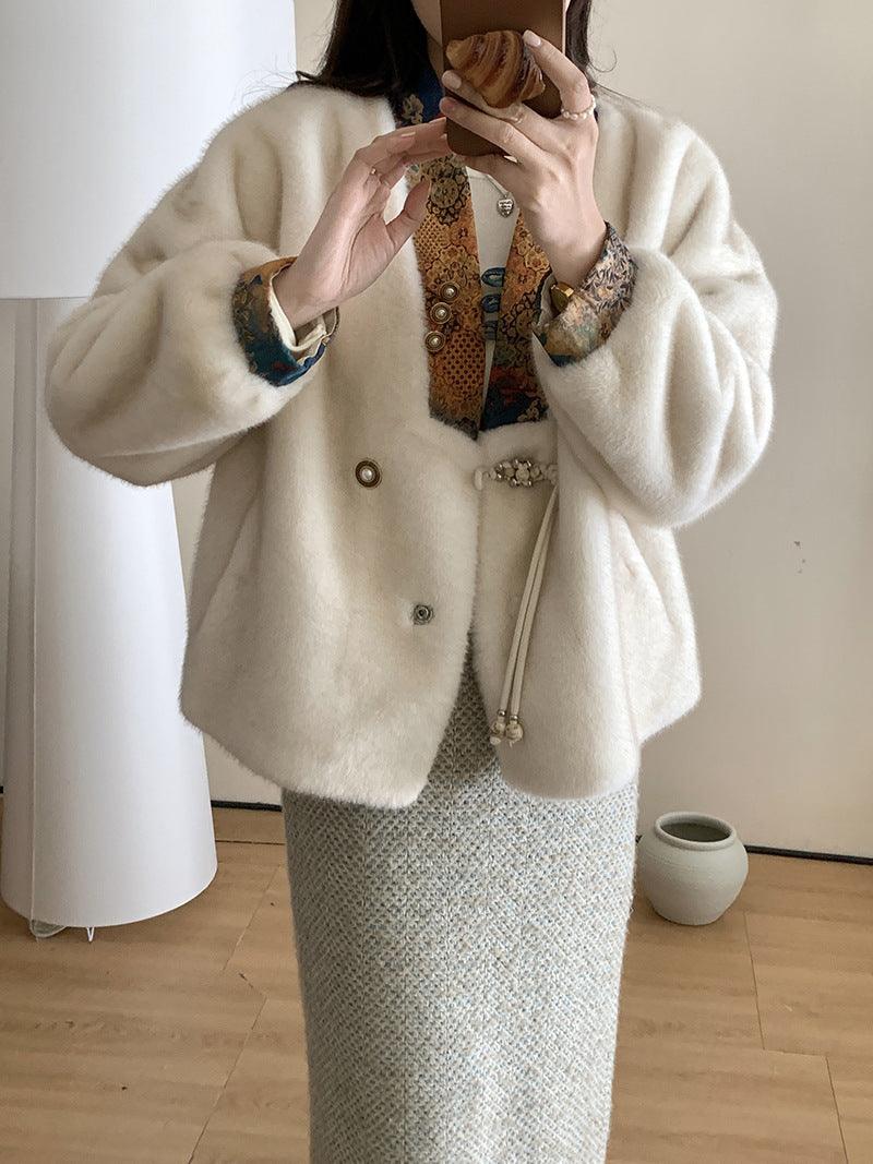Cream mink fashion coat with button front, wide sleeves, and decorative brooch detail
