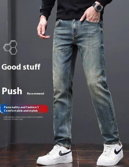 Men's light blue denim jeans with distressed patches at thighs and worn cuffs