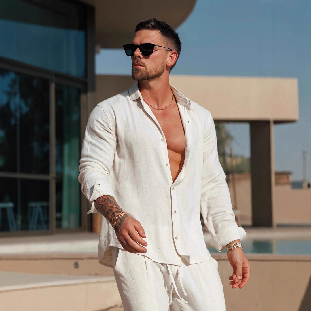 Cream long-sleeve button-up shirt with open collar, front buttons, and chest pocket