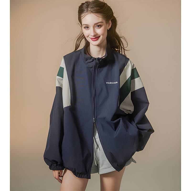 Women’s dark blue zip-up coat with white and green color-block sleeves