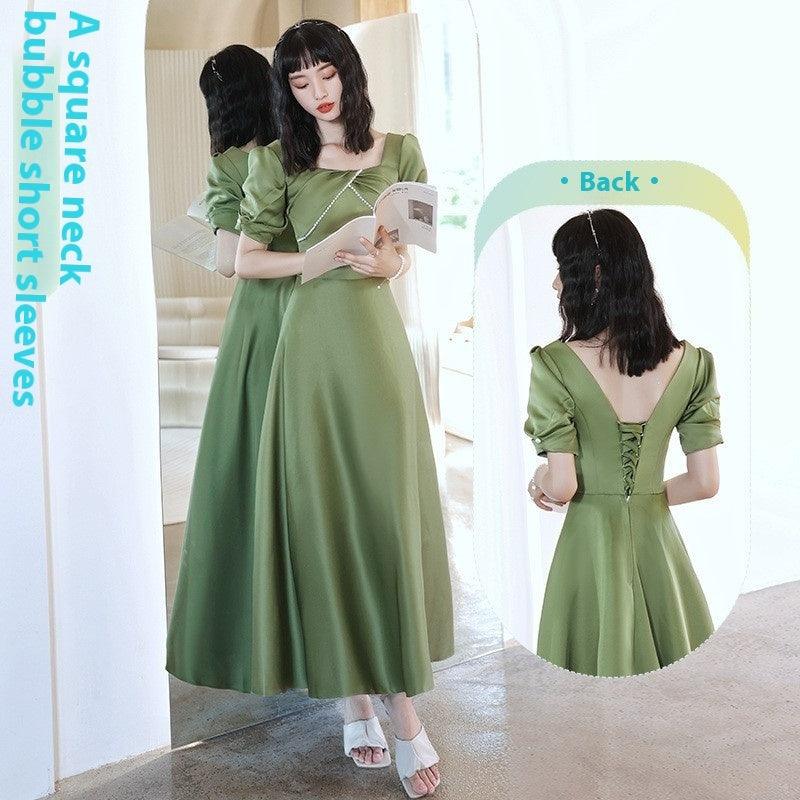 Green midi dress with puff sleeves and button back; wide skirt with gathered flare