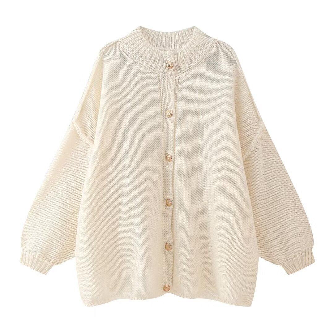 Cream knit button-front batwing-sleeve jacket with round neckline and gold buttons
