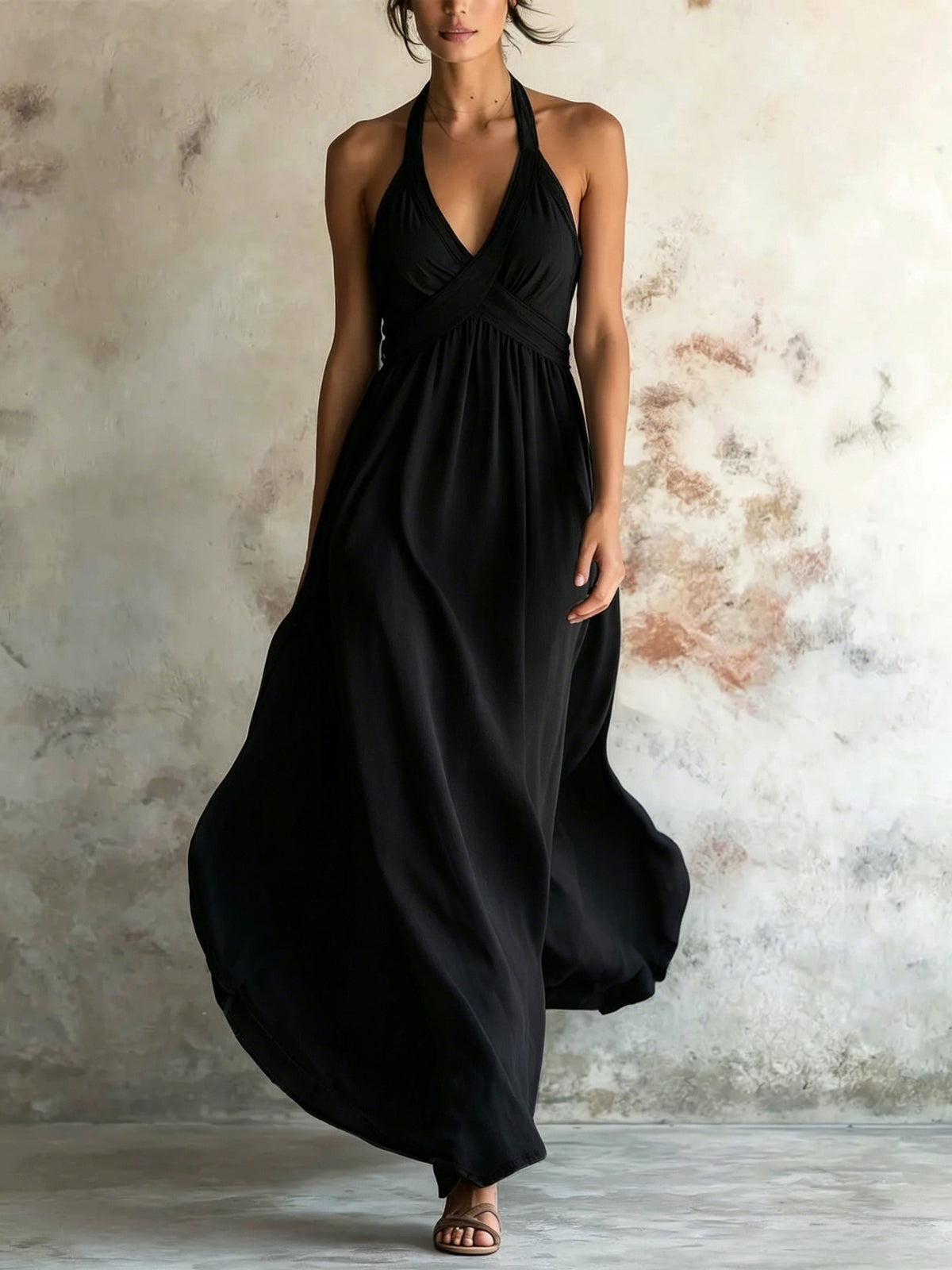 Black sleeveless flared maxi dress with halter V-neck and gathered waist