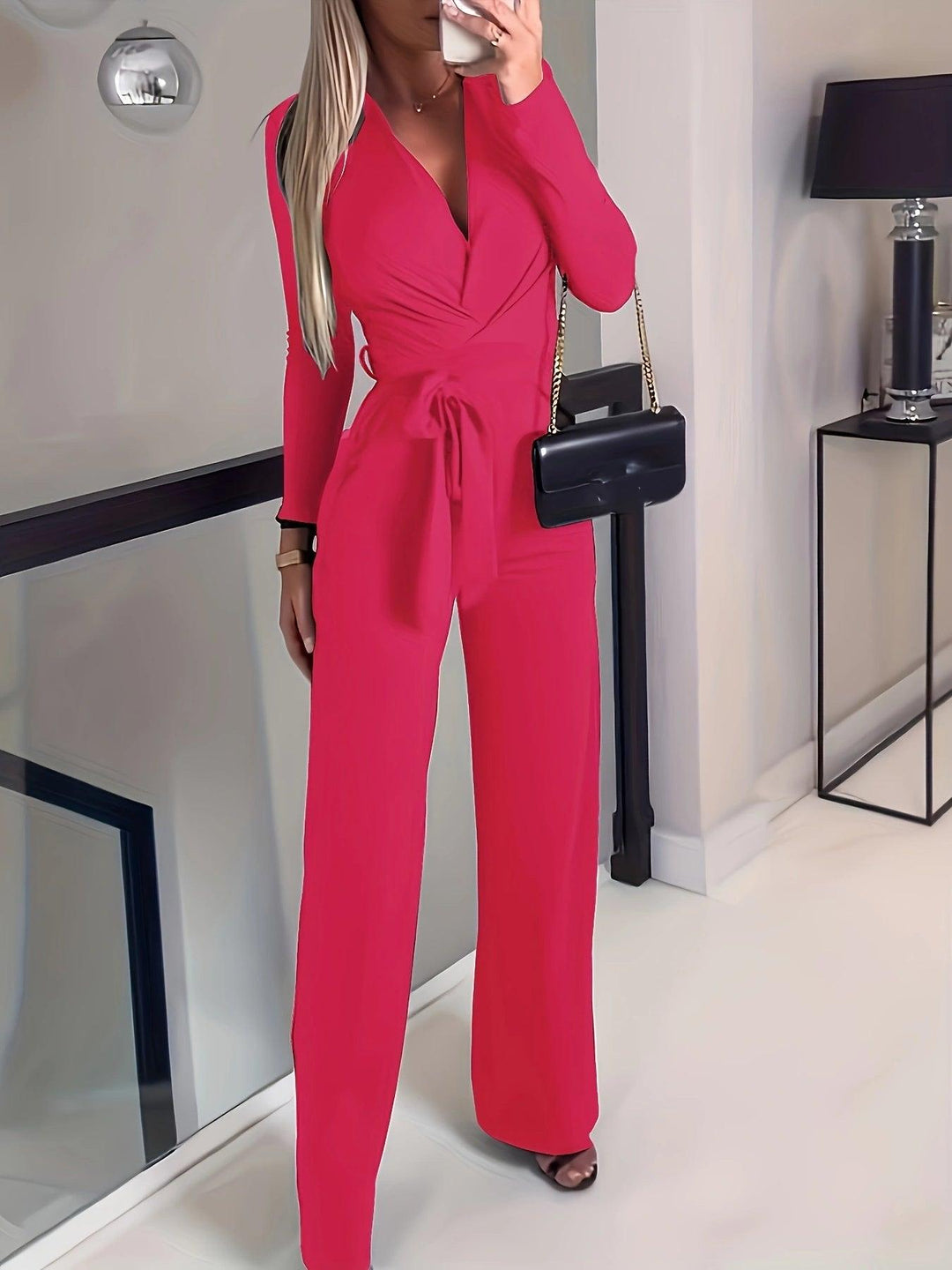 Red V-neck long-sleeve jumpsuit with waist tie and wide-leg slim fit