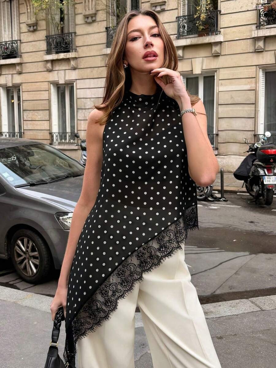 Black sleeveless top with white polka dots and scalloped lace-trim edge