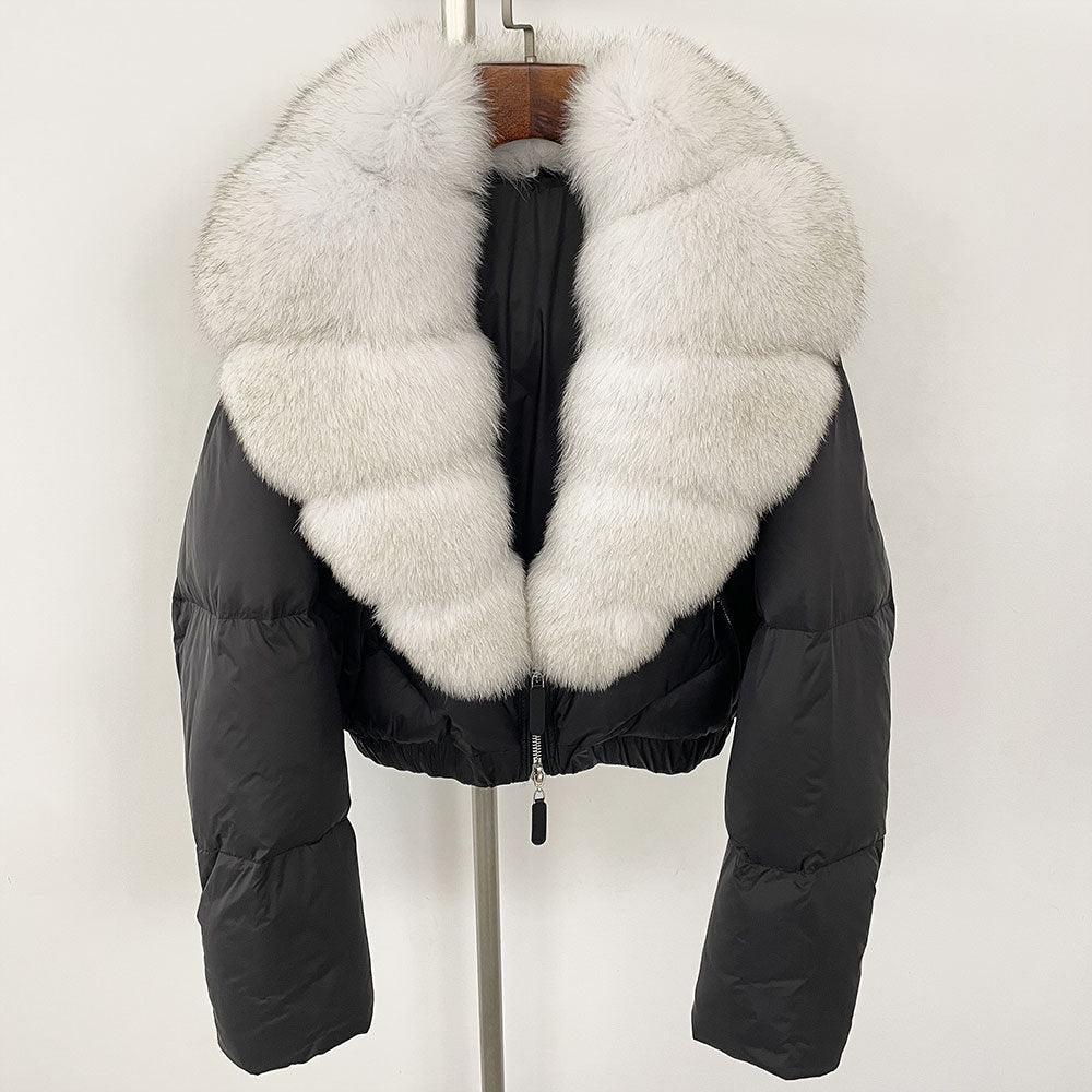 Short puffer down jacket with thick white fox fur collar and front zipper, black exterior.