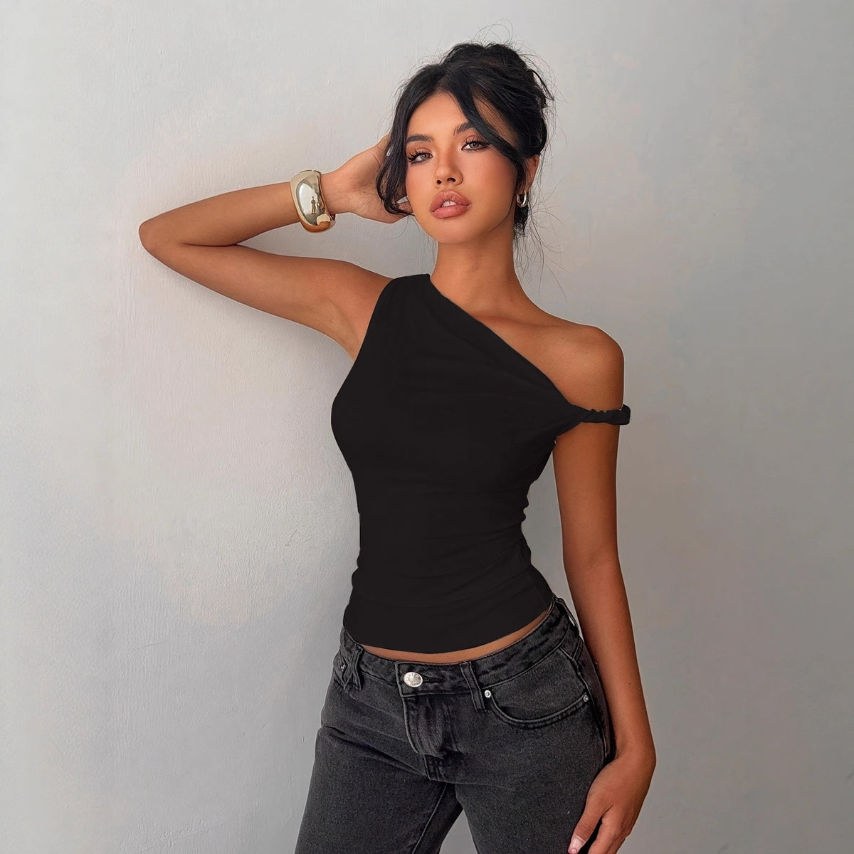 Black one-shoulder knot-front short-sleeve top with draped wrap neckline.