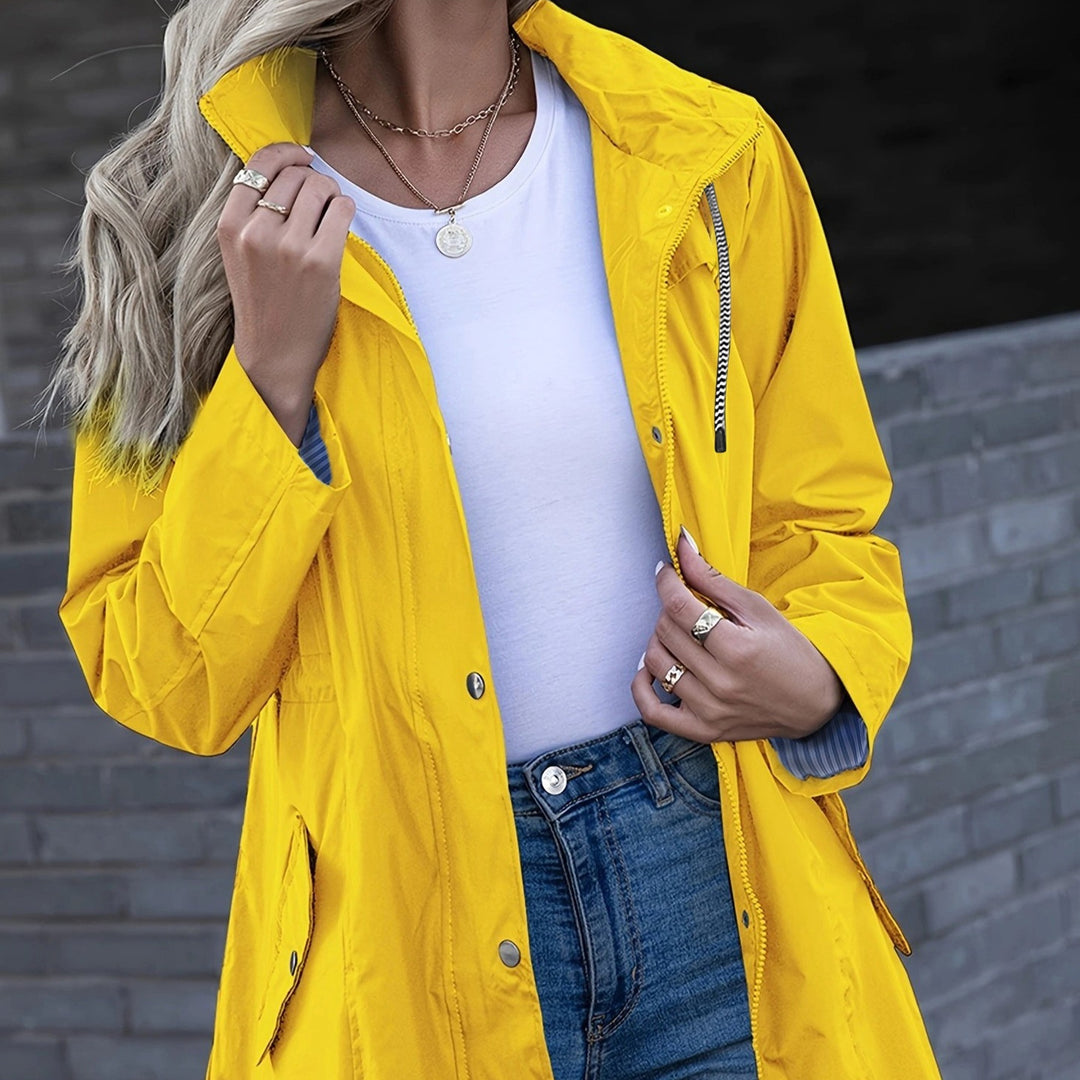 Yellow waterproof hiking jacket with hood, zip pocket, and button front