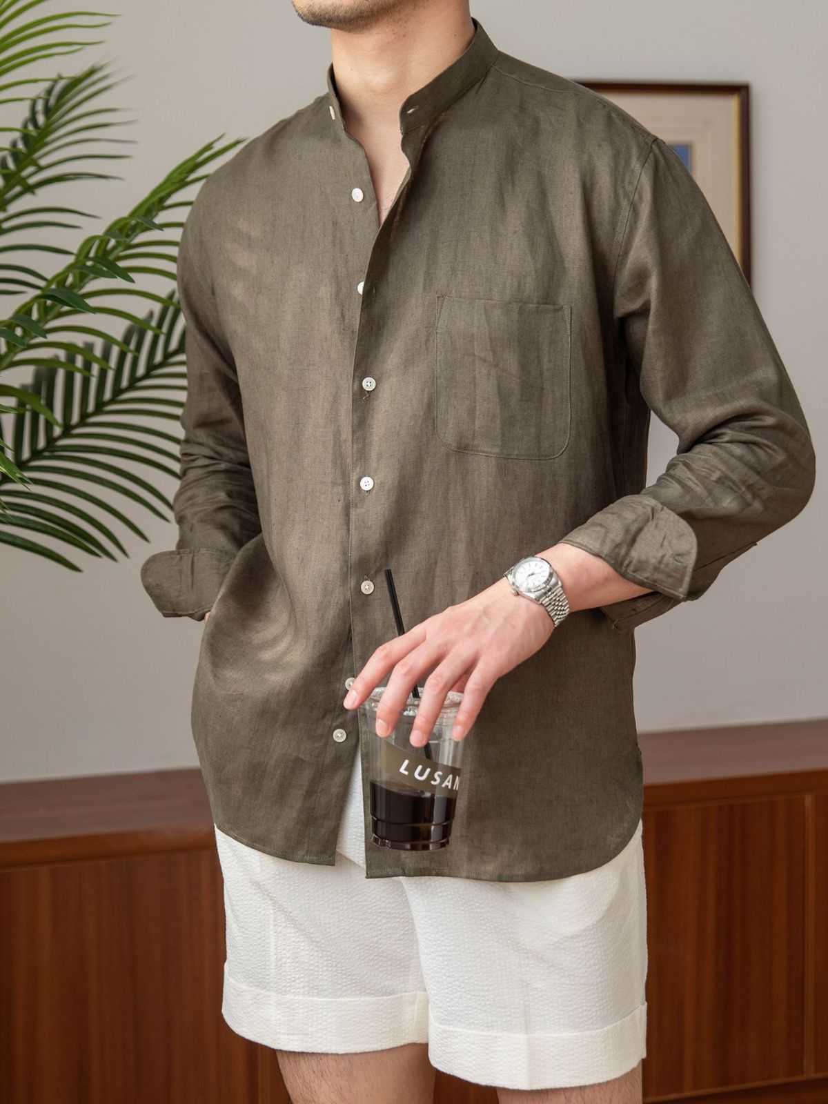 Brown long-sleeve resort shirt with stand-up collar, front buttons, and chest pocket