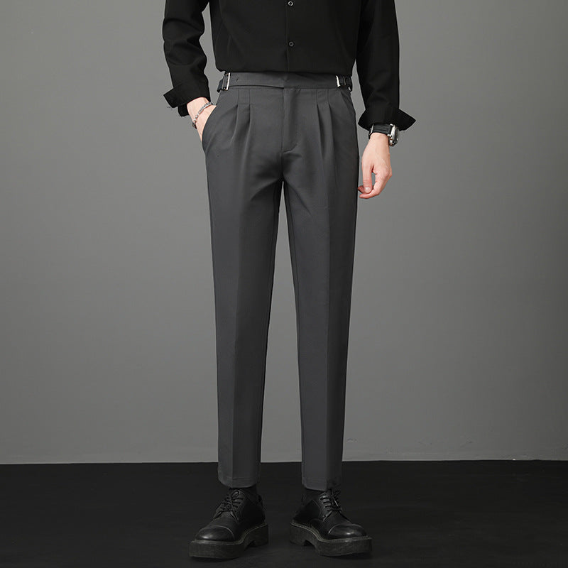Slim-fit young men’s suit trousers in dark gray, flat front, belt loops, tailored straight legs.
