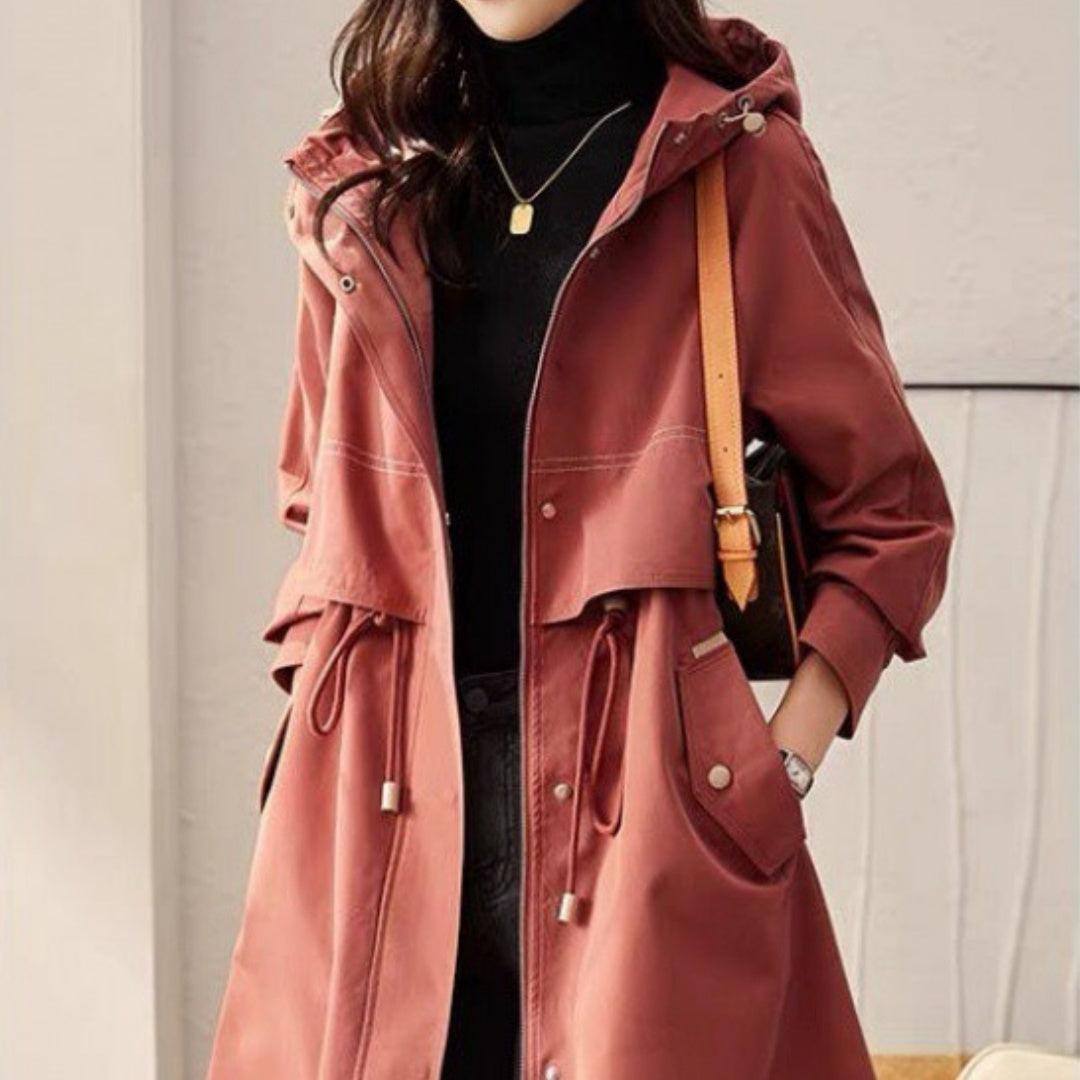 Maroon hooded windbreaker coat with drawstring waist, front zipper, and flap pockets