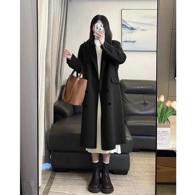 Women’s black long wool coat with double-breasted button front and side flap pockets