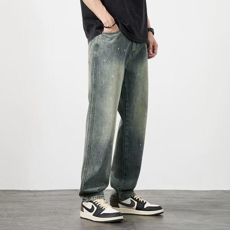 Men’s high-waist distressed jeans in light blue with splatter specks and wide legs