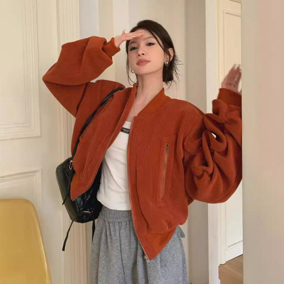 Orange corduroy zip-up jacket with padded pleated sleeves