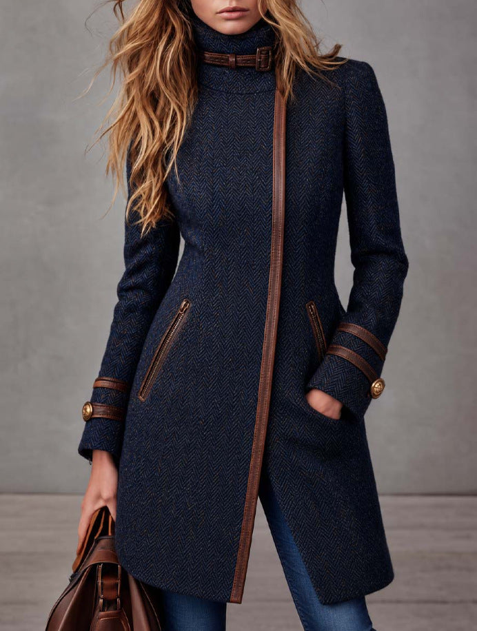 Navy herringbone tweed coat with side zipper, mock neck, and brown leather pocket details