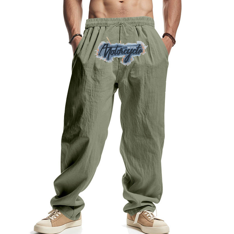 Men's sage green wide-leg pants with elastic drawstring waist and colorful chest logo