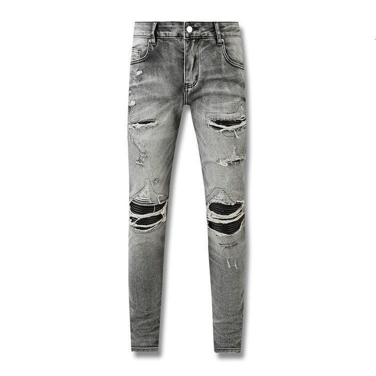 Grey distressed slim-fit pants with ripped knees and tapered legs