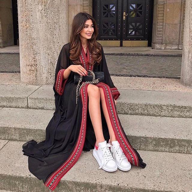 Black swimsuit cover-up cardigan with red trim, long sleeves and tied waist