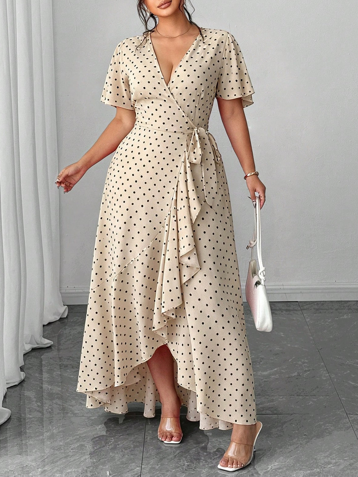 Beige polka-dot V-neck midi dress with short sleeves, waist tie, and asymmetrical layered hem