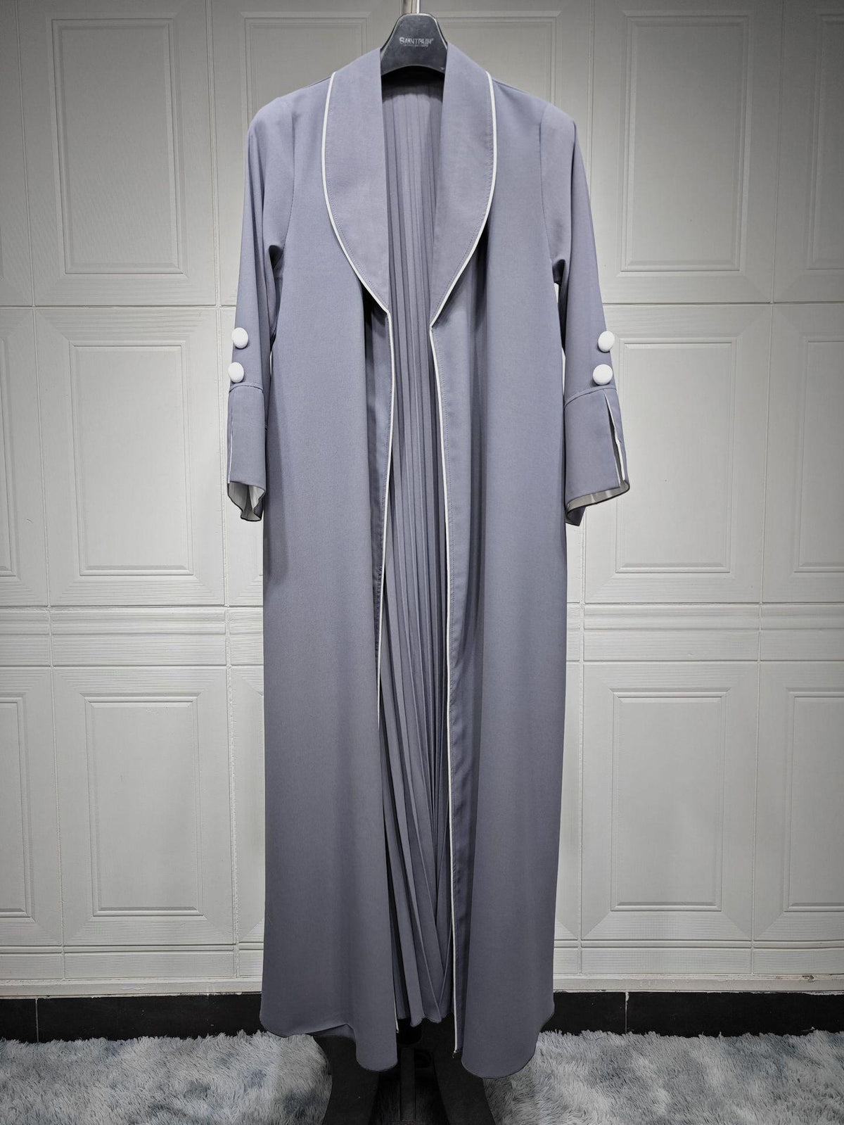 Long cardigan dress in light grey with open V lapel and white trim accents on cuffs.
