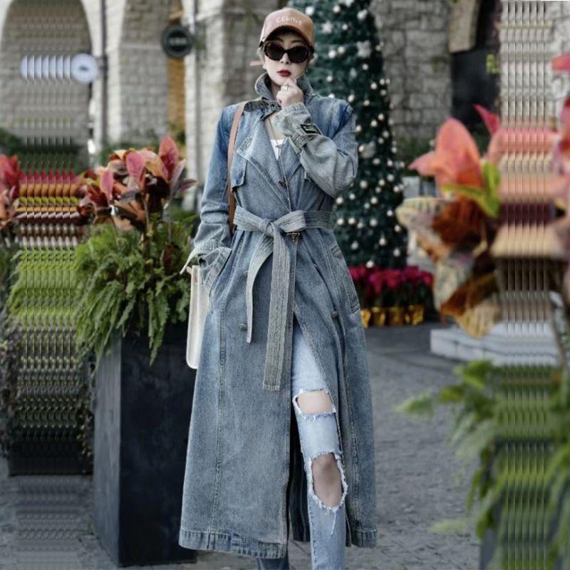 Light blue denim long trench coat with removable-looking belt and chest buttons