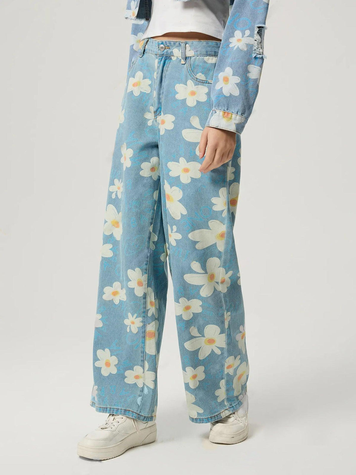 Blue straight jeans with allover daisy floral print, front button closure and belt loops
