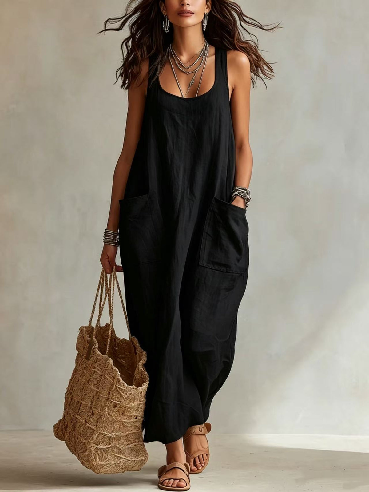 Black long sleeveless slip dress with scoop neck and side patch pockets