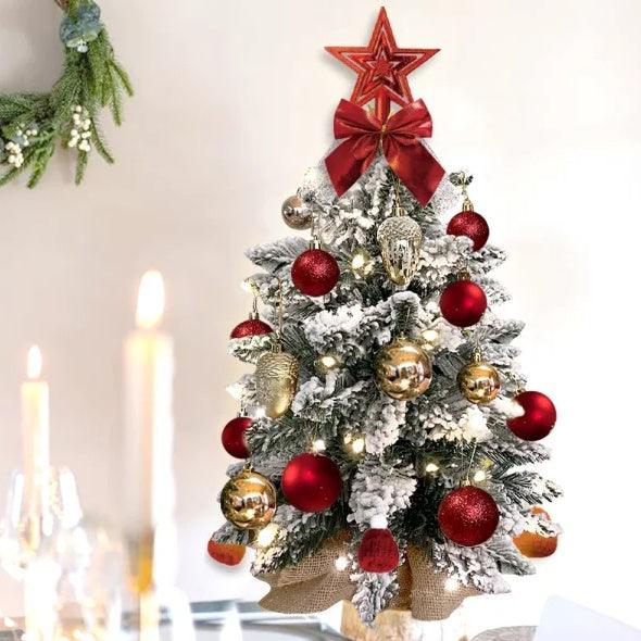 Flocked mini Christmas tree with warm lights, red star topper, and red/gold ornament balls