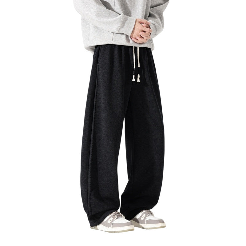 Men's black casual jogger pants with drawstring waist and relaxed wide legs