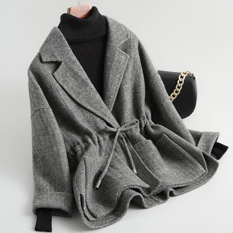 Gray short wool coat with notched lapels and tie waist, textured herringbone weave